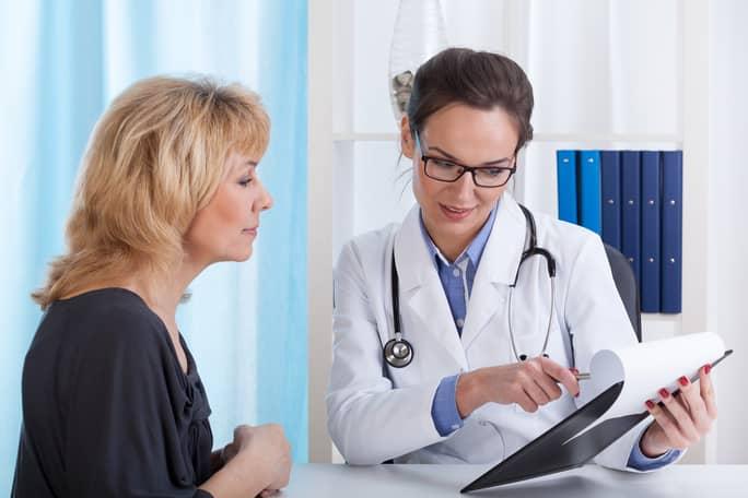 A woman receiving a consultation with a doctor